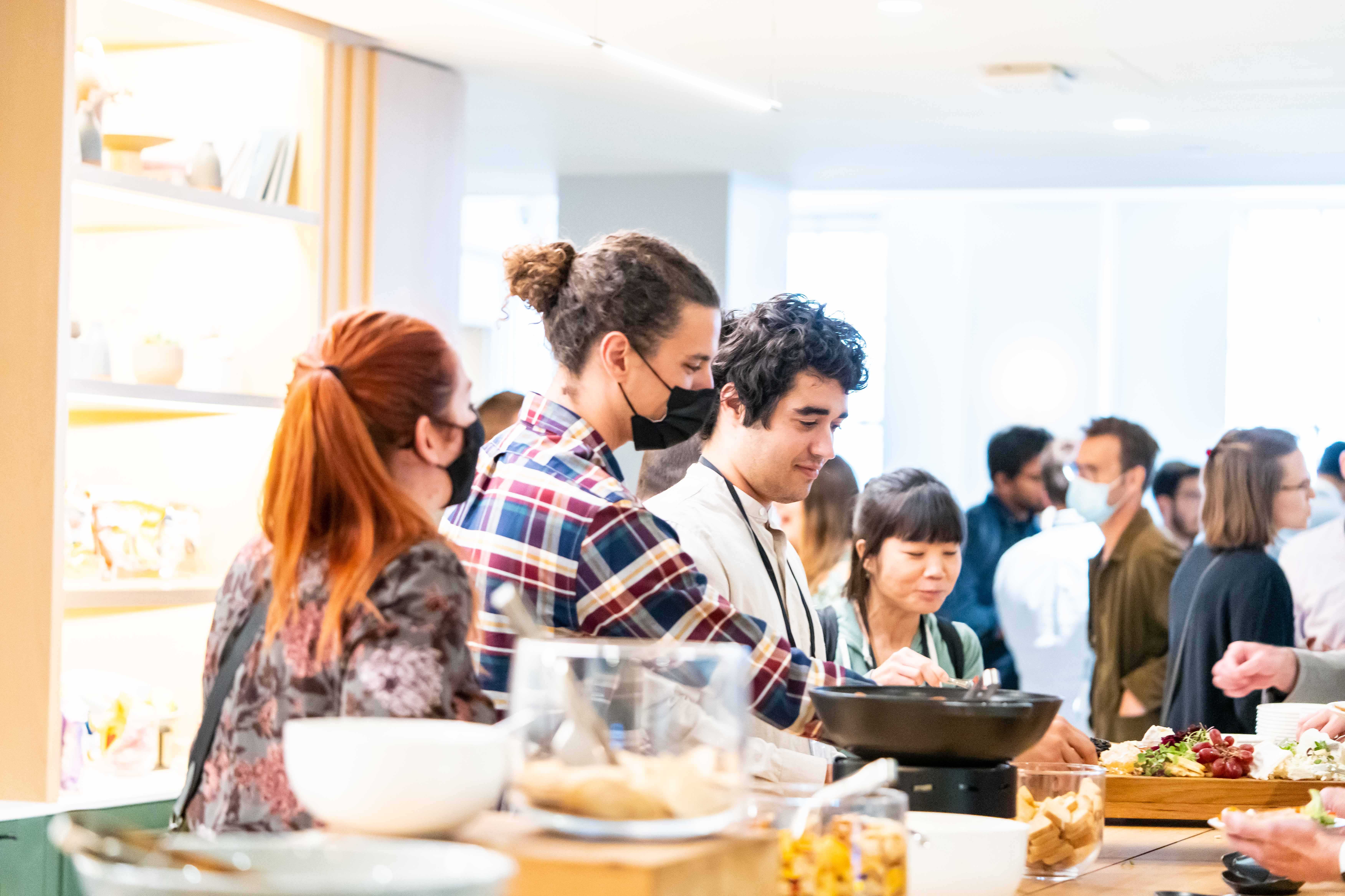 Group of people grabbing snacks during a break